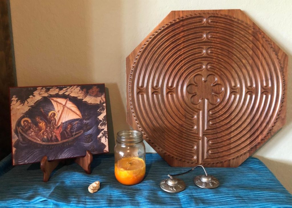 Zen table with a candle a zen maze and a picture of Jesus in a boat with disciples 